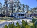 Charming ranch home with a metal roof, carport, and spacious front porch at 202 Briarwood St, Walterboro, SC 29488