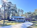 Charming ranch home with a metal roof, carport, and spacious front porch at 202 Briarwood St, Walterboro, SC 29488