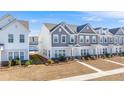 Two-story townhouses with gray and white siding, landscaping, and walkways at 240 Godwit Dr, Summerville, SC 29486