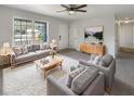 Bright living room with gray couches, coffee table, and large window at 3 Tommy Cir, Goose Creek, SC 29445