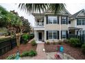 Two-story house with balcony, brick pathway, and landscaped yard with seating area at 3001 Parkwest Boulevard, Mount Pleasant, SC 29466