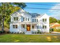 Two story white house with a covered porch and manicured lawn at 362 6Th Ave, Mount Pleasant, SC 29464