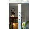 Front entry with a wooden door, lantern light, and potted plants at 362 6Th Ave, Mount Pleasant, SC 29464