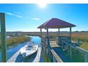 Wooden dock with gazebo, floating boat slip, and tranquil marsh views at 363 Clayton Dr, Charleston, SC 29414