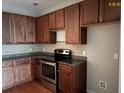 Kitchen boasts wood cabinets, granite counters, and stainless steel appliances at 407 Hemingway Cir, Summerville, SC 29483