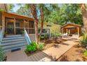 Outdoor space with deck, pergola, tropical landscaping, and walkway at 420 E Erie Ave, Folly Beach, SC 29439