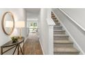 Bright and airy entryway with hardwood floors, staircase, and a console table at 526 Golden Embers Way, Summerville, SC 29486