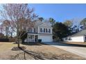 Two-story house with beige siding, white garage door, and a porch at 611 Resinwood Rd, Moncks Corner, SC 29461