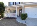 Front porch with white railing, and dark brown door at 611 Resinwood Rd, Moncks Corner, SC 29461