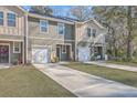 View of townhouses with attached garages and manicured lawns at 8410 Hidden Bakers Trce, North Charleston, SC 29418