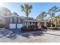 Brick ranch home with two-car garage and mature landscaping at 1081 Saint Thomas Island Dr, Charleston, SC 29492