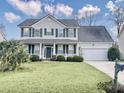 Two-story house with green shutters, white siding, and a two-car garage at 173 Hainsworth Dr, North Charleston, SC 29418