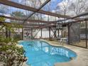 Enclosed kidney-shaped pool with a wooden pergola cover at 173 Hainsworth Dr, North Charleston, SC 29418