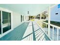 Long, covered porch with white railings and light teal flooring at 1966 Suzanne St, Johns Island, SC 29455