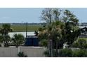 Scenic view of marsh grasses, water, and distant buildings at 3701 Dock Site Rd # 205, Edisto Beach, SC 29438