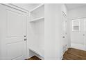 White laundry room with built-in bench and shelving at 428 Grove End Rd, Moncks Corner, SC 29461