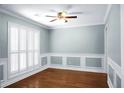 Formal dining room with hardwood floors, wainscoting, and plantation shutters at 5382 Westchester Pl, North Charleston, SC 29418