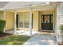 Inviting front porch with white columns and a black front door at 5382 Westchester Pl, North Charleston, SC 29418