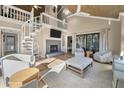 Open living space with high ceilings, fireplace, and spiral staircase at 604 Magnolia Walk, Edisto Island, SC 29438