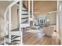 Modern spiral staircase leading to an upper loft area at 604 Magnolia Walk, Edisto Island, SC 29438