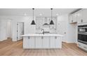 Modern kitchen with white cabinets, quartz island, and black appliances at 1137 Happyland Blvd, Mount Pleasant, SC 29466
