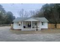 Charming white house with a front porch and fenced yard at 1420 Old Whitesville Rd, Moncks Corner, SC 29461