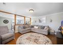 Bright living room with hardwood floors, sectional sofa, and a large window at 1420 Old Whitesville Rd, Moncks Corner, SC 29461