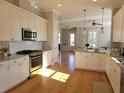 Bright kitchen with white cabinets, granite countertops, and stainless steel appliances at 1617 Bowsprit Ct, Mount Pleasant, SC 29466