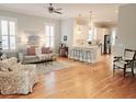 Open living room with hardwood floors, a sofa, and a view into the kitchen at 1617 Bowsprit Ct, Mount Pleasant, SC 29466