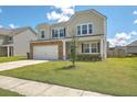 Two-story house with stone accents, a front porch, and a well-maintained lawn at 238 Wathen Dr, Goose Creek, SC 29445