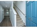Light-colored entryway with carpeted stairs and blue door at 275 Jackson St, Goose Creek, SC 29445