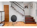 Modern staircase with glass railings and dark wood steps at 301 Broad St # 1, Charleston, SC 29401