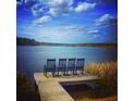 Four rocking chairs on a dock overlooking a tranquil lake at 323 Hillman Trl Dr, Moncks Corner, SC 29461