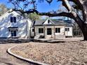 White farmhouse with a covered porch and landscaping at 3874 Srevir Rd, Johns Island, SC 29455