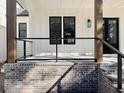 Covered porch with wood posts and cable railing at 3874 Srevir Rd, Johns Island, SC 29455