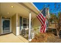 Inviting front porch with American flag and rocking chair at 104 Pavilion St, Summerville, SC 29483