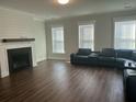 Living room with fireplace, hardwood floors, and black reclining sofa at 106 Helena Park Dr Dr, Summerville, SC 29486