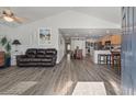 Open floor plan with gray floors, leather couch, and kitchen view at 1290 Palm Cove Dr, Charleston, SC 29492
