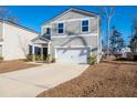 Two-story house with gray siding, white garage door, and driveway at 134 Vistawood Dr, Charleston, SC 29414