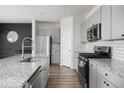 Modern kitchen with gray cabinets, granite countertops, and stainless steel appliances at 134 Vistawood Dr, Charleston, SC 29414