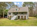 Two story house with a large front yard and driveway at 1575 Tacky Point Rd, Wadmalaw Island, SC 29487