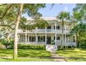 Two story home with wrap around porch and mature landscaping at 1750 Ion Ave, Sullivans Island, SC 29482