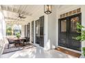 Relaxing front porch with seating area and dining table at 1750 Ion Ave, Sullivans Island, SC 29482