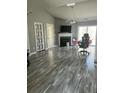 Spacious living room featuring gray vinyl plank flooring and a fireplace at 214 Hardee Ave Ave, Summerville, SC 29485
