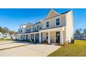 Row of townhomes featuring neutral siding and front porches at 233 Abercom Place Dr, Moncks Corner, SC 29461