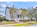Two-story house with gray siding, white trim, and palm trees at 2433 Louisville St, Charleston, SC 29492