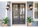Double front doors with glass panels and black finish at 2433 Louisville St, Charleston, SC 29492