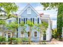 Beautiful light blue two-story home with lush landscaping at 27 Chapel St, Charleston, SC 29403