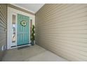 Inviting teal front door with wreath and sidelights at 274 Tupelo Lake Dr, Summerville, SC 29486