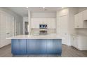 Modern kitchen with blue island, white cabinets, and stainless steel appliances at 2837 Auldreeke Rd, Johns Island, SC 29455